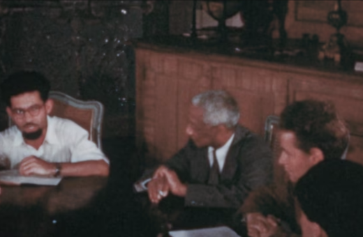 Still from the film, of a group of scholars around the table at Schloss Leopoldskron.
