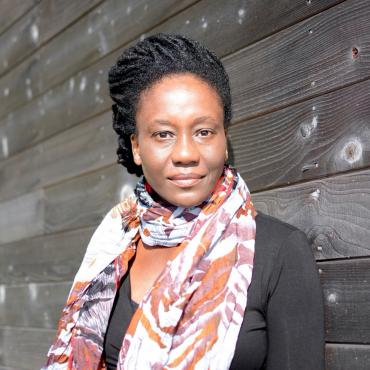 Catina Bacote, a Black woman writer, stands outside her studio at the Djerassi Resident Artist Program.