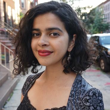 The author standing outside on a sidewalk