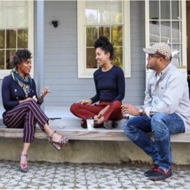 People sitting on a patio and chatting.