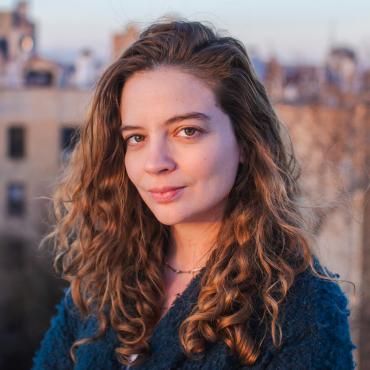 Chloe Sarbib, a thirty-something white woman, looking at the camera