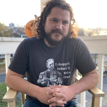 Charlie Ainsworth, a thirty-something white man, smiles at the camera.