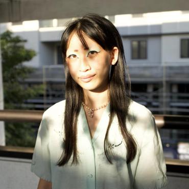 Julia Chien, a twenty-something Taiwanese-American woman, smiling at the camera