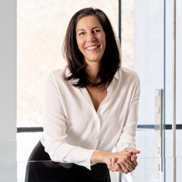 Debra Wimpfheimer standing in a hallway in the Queens Museum